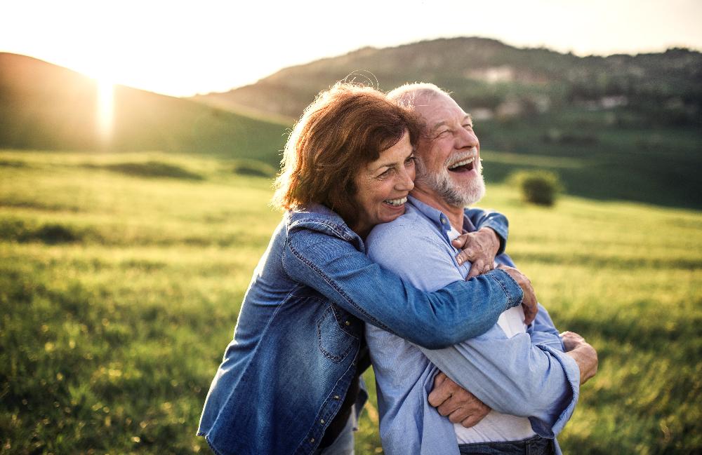 older couple smiling outside | dental implants near me