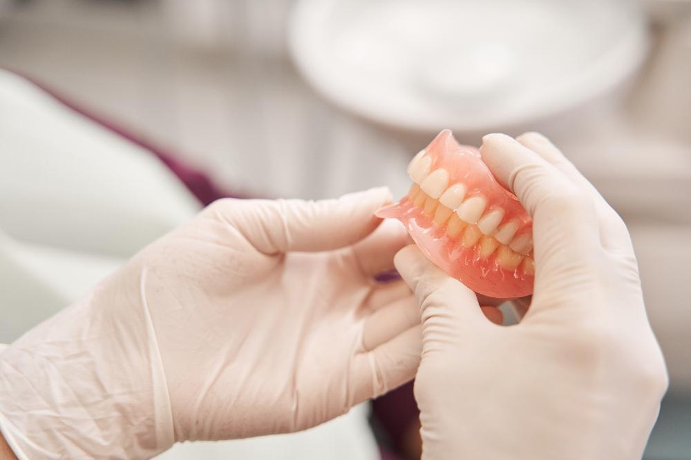 dentist holding dentures | dentured medina oh