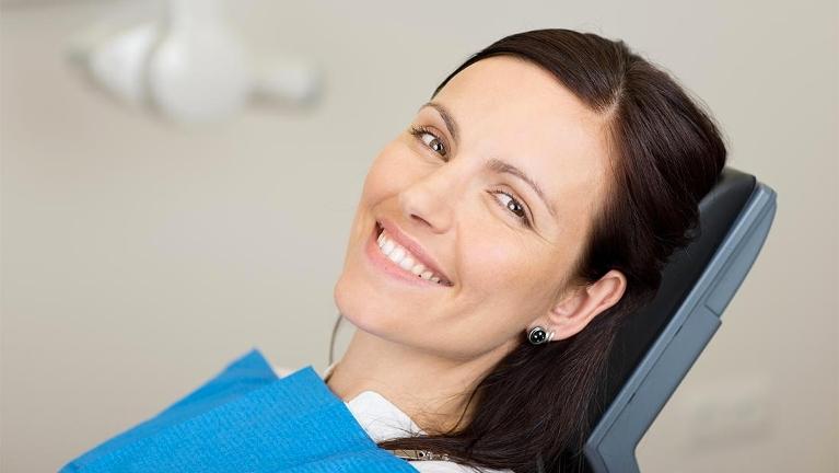 prosthodontist medina, OH | woman in dental chair