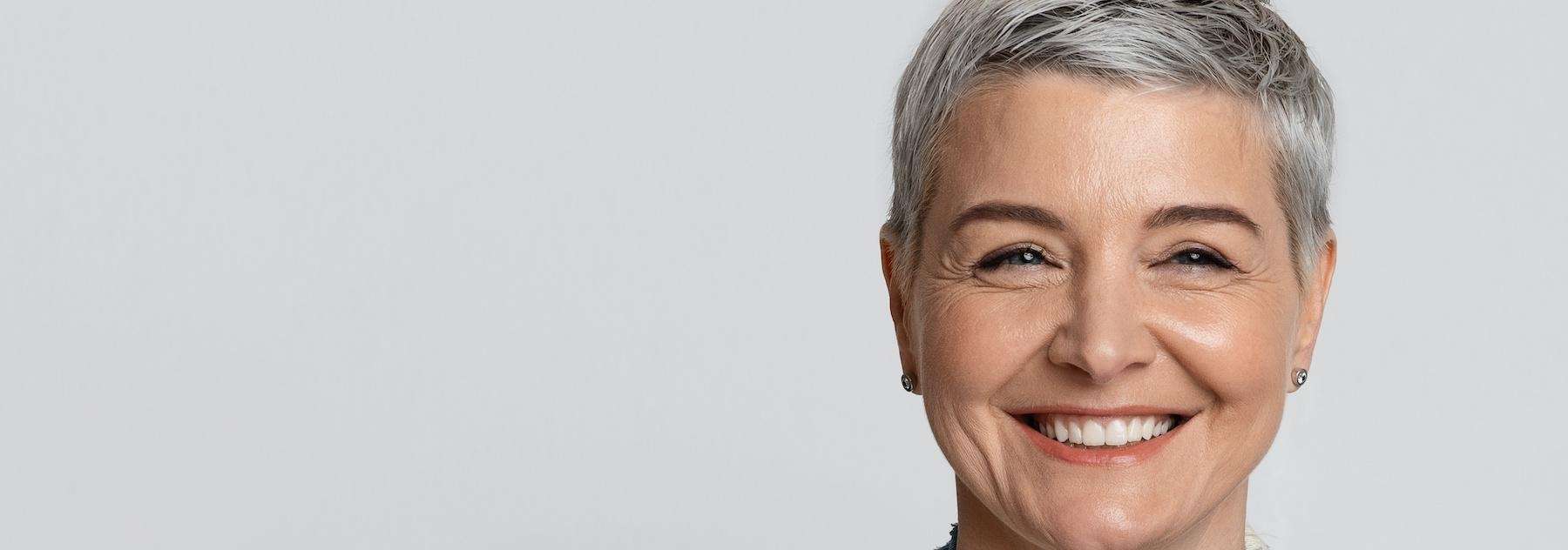 woman with silver hair | dental implants near me